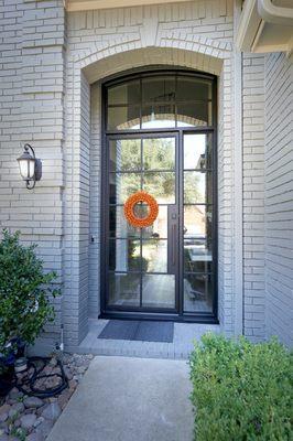 Compliment your home with a custom entryway. Here's a contemporary single door with custom window paneling!