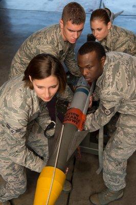 Weapons Crew preparing to load a missile on a F-15D Eagle.