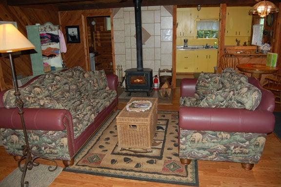 Carriage House has a beautiful wildlife tapestry and leather couch and love seat