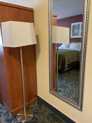 Full size mirror at entrance and lamp.