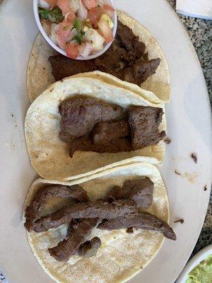 This is the three carne asada tacos . They were very dry.Almost like beef jerky. As you can see , those are some very sad looking tacos.