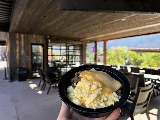 Sausage, egg, potato breakfast bowl (dry, could use salsa) - covered outdoor eating space