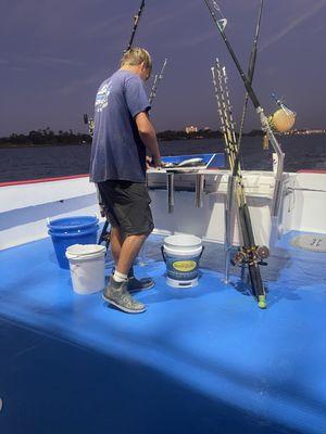 Deck hand Christian getting bait ready before our trip