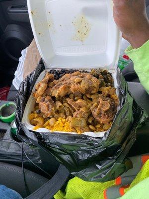 Oxtail with curry rice,black beans, greens and coco bread