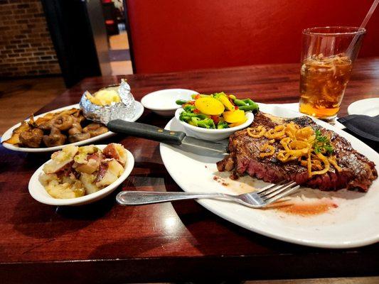 Ribbon steak, mixed vegetables, house red potatoes, Baked potato with sour cream, and a sweet tea