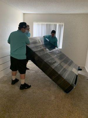 The team is properly disassembling and shrink wrapping a bed set