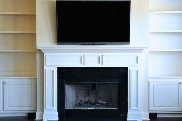 TV mounted over fireplace custom wire concealment