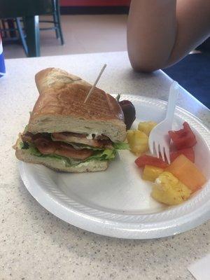 BLT with fruit salad as the side and chocolate covered strawberry for the dessert.