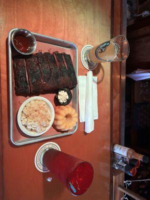 Half rack of ribs with kc sauce on the side, mac n cheese, cornbread