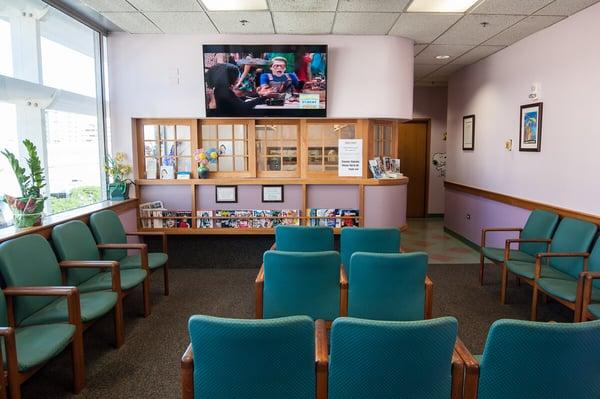 Waiting room with large flat screen TV.