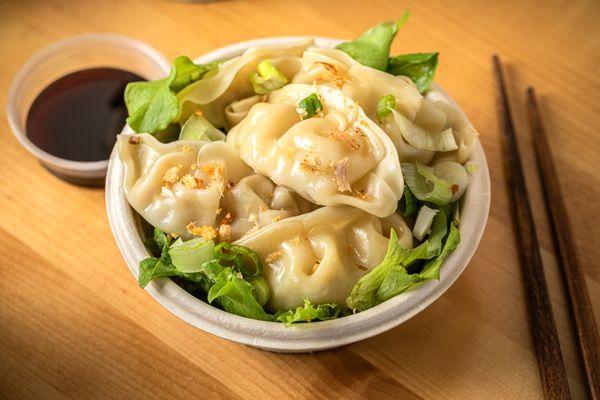 Steamed Chicken Gyoza  Tender, juicy chicken wrapped in a soft, delicate dough, steamed to perfection. A delightful, flavorful bite .