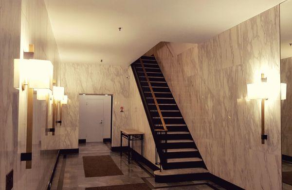 Choice of beautiful Shaded brass fixtures makes quite the impression on the guests. Warm lights accentuate the beautiful marble walls.