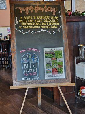 Close-up of the sign near the entrance with the latest news, including the Burger of the Day.