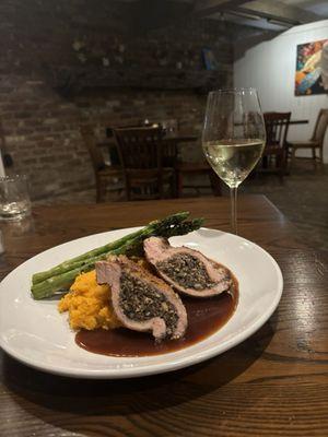 Pork chop stuffed with cremini mushrooms served over a bed of sweet mashed potatoes and grilled asparagus.