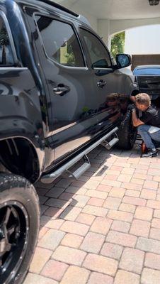 Owner and detailer, Eric, detailing wheels of Toyota Tacoma as part of MAD Diamond package.