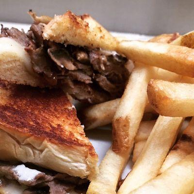 The Broadway Melt. Shaved steak, mushrooms, onion, provolone cheese, and mayo served on Texas Toast with a side of fires.