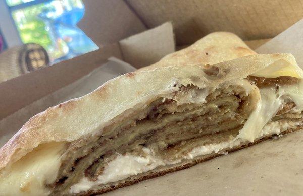 Side view of a medium Calzone w Eggplant. (Lite Bake requested). Delicious!!!