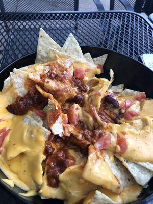 Nasty soggy nachos, if you enjoy cheese whiz and Hormel chili in the microwave, this dish is for you.