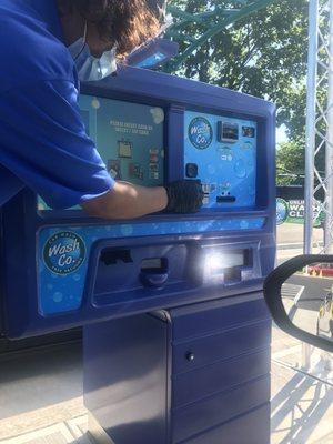 One of the Wash Co's employees explaining how to use your credit card to pay for your car wash