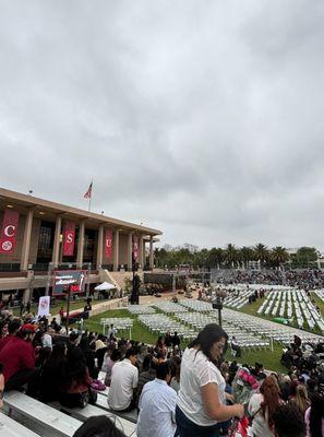 Graduation ceremonies held in front of the of the library. May 2024.