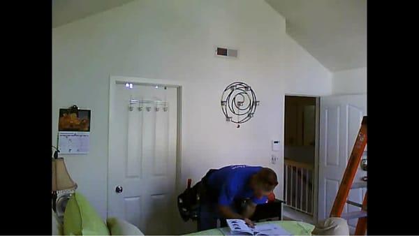 Matt is carefully reading the ceiling fan's specs and instructions:  Hunter's Westover fan has a heater inside the ceiling fan.