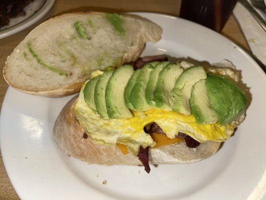 The Cali - bacon scrambled egg cheddar avocado on lightly grilled Italian bread