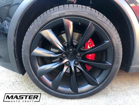 Tesla. Custom wheel powder coating (satin black). Custom caliper painting (Ferrari Rossi red). Package pricing available.