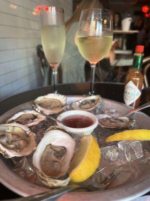 Happy hour special 1/2 dozen oysters and a glass of wine.