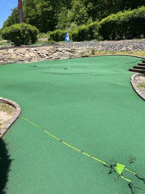 Damaged mini golf hole