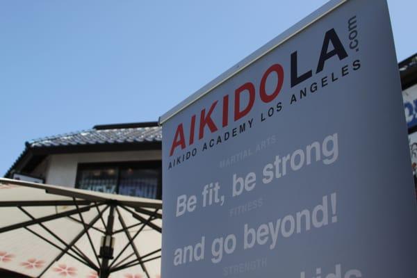 AikidoAcademy Los Angeles banner in Little Tokyo in DTLA during Japanese week festival. Aikido presentation, martial arts exhibition.