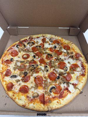 Fresh made pizza with pepperoni, sausage and mushroom