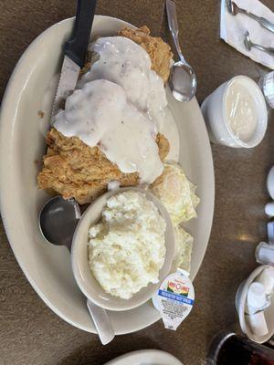 Fried pork chops, eggs and grits