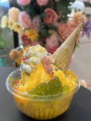 Mango snowy ice with kiki boba pop and mango star jelly it's the best shaved ice in New York !