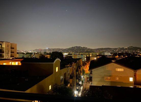 Roof top view at night near fire pit.