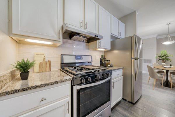 Kitchen with hardwood style flooring and stainless steel appliances