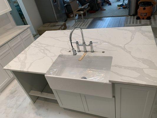 Beautiful Quartz countertops with Farm style porcelain single bowl sink.