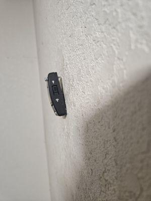 The button hanging out of the wall. The way it has been since they were at my home.