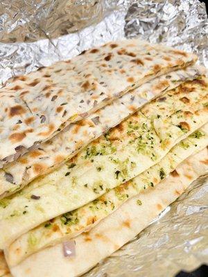 Several types of naan:  Assorted Bread Basket