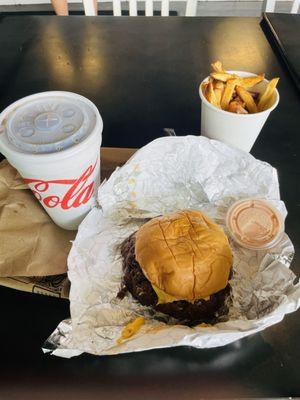 Double cheeseburger with caramelized onions, cheese,sweet crispy pickles,fries,best sauce and a Coke