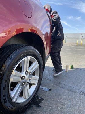 My guy putting some protective gear on my tires and wiping down my car. Always good to tip.