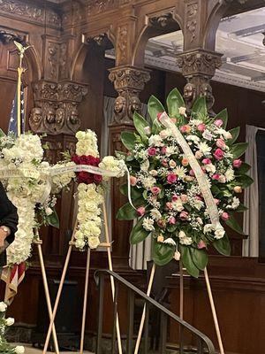 The Holy Cross standing flowers with red roses at the middle and background white roses.