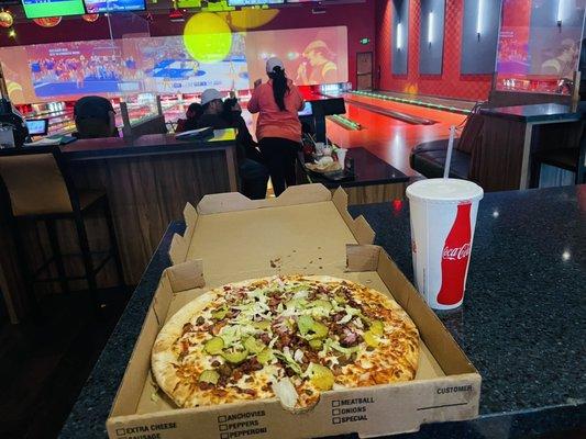 My pizza with the view of a family enjoying the bowling Alley!