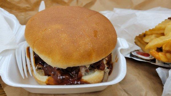 BBQ pork sandwich with a side of crinkle cut fries