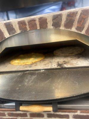 Our brick oven pizza in action cooking over 600 degrees.