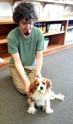 Ben, giving the best pet massage to one of our most favorite customers, Corky!