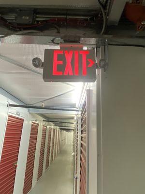 Hallway, with security camera behind Exit sign pointing to my unit.