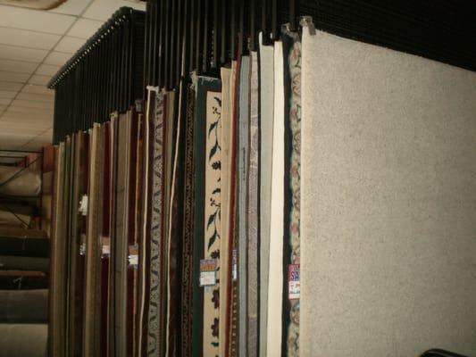 Several racks of Discounted customer area rugs, or let us make the size you want from any stock or ordered carpet.