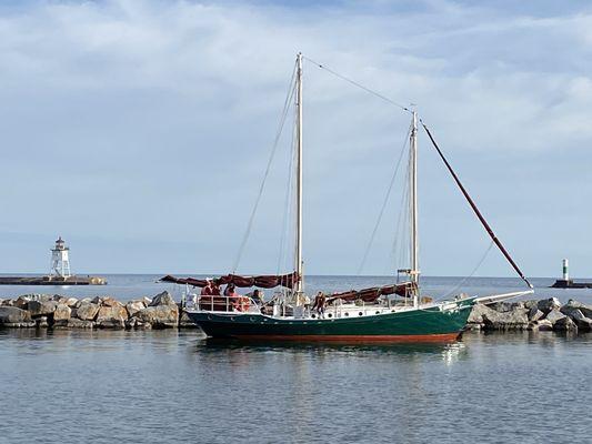 Sailboat going by the Angry Trout to dock.