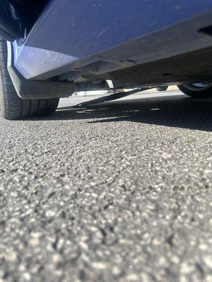 Skid plate hanging from Valvoline "tech's" forgetting to bolt it back up.