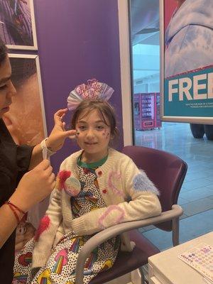 The birthday girl getting face gems